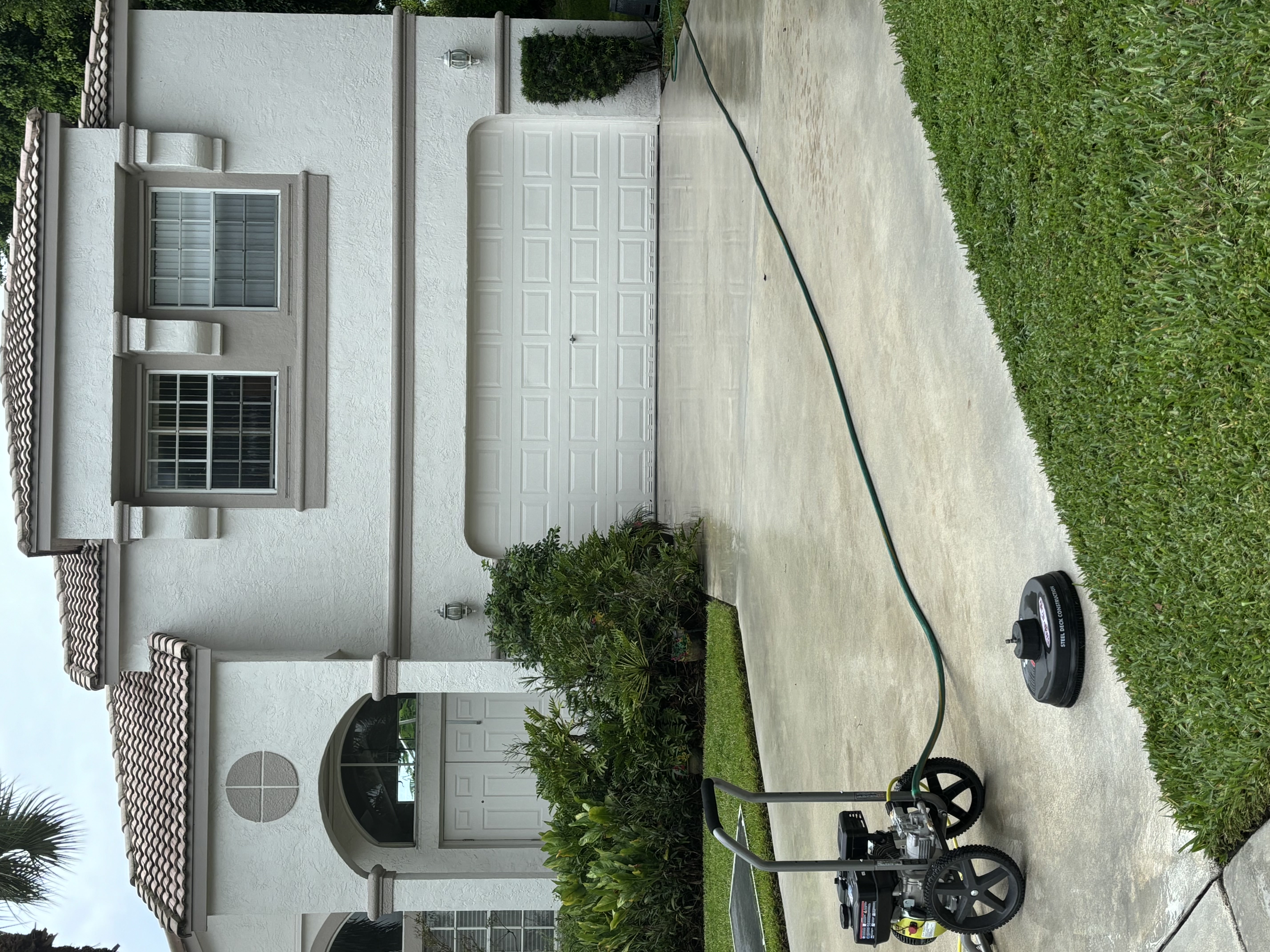 A clean driveway after pressure washing service
